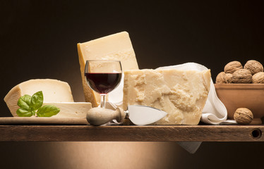 Still life with parmesan cheese on the wooden table