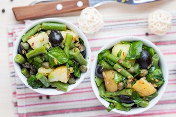 Potato salad with green beans, olives, capers, onions, delicious