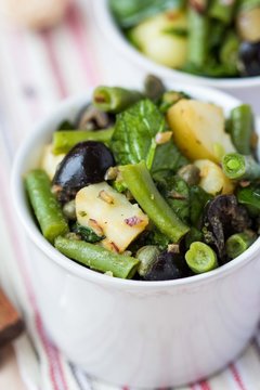 Potato salad with green beans, olives, capers, onions, delicious