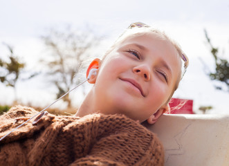 portrait of a pretty blonde girl with headphones