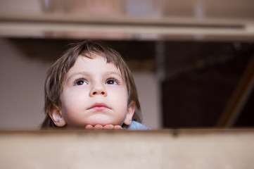 sad little boy thinking looking up