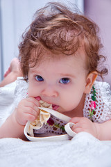 Cute baby girl chewing a rim