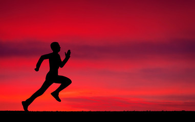 Fototapeta na wymiar Silhouette of running man on sunset fiery background