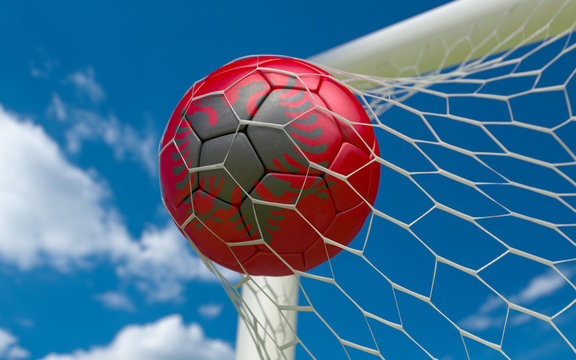 Flag of Albania and soccer ball in goal net