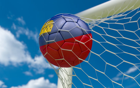Flag of Liechtenstein and soccer ball in goal net