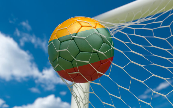 Flag of Lithuania and soccer ball in goal net