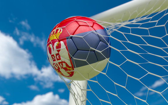 Flag of Serbia and soccer ball in goal net