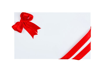 Close up of  card with red ribbon bow on white background