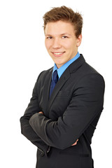 Young businessman at suit standing with folded hands
