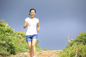 woman running on mountain stairs
