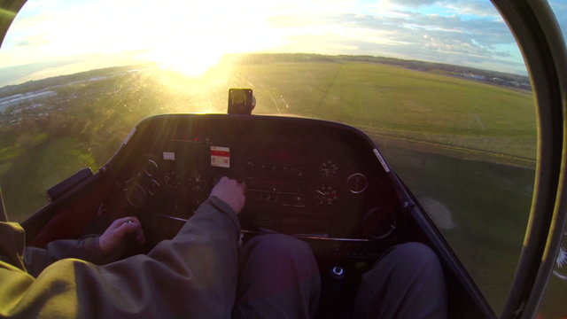 Small prop plane landing at sunset view from cockpit