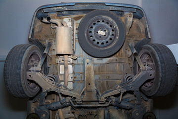 Fototapeta Car underbody rear wheels exhaust pipe and suspensions obraz