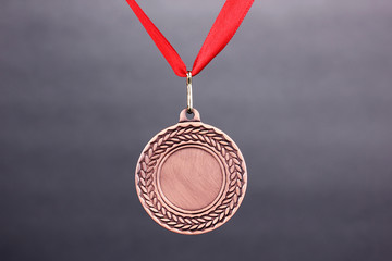 Three medals on grey background