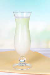 Milk shake on table on light blue background