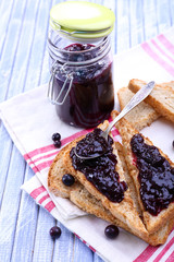 Delicious toast with jam on table close-up
