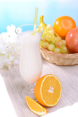 Milk shake on table on light blue background