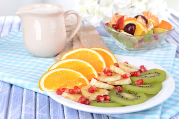 Sweet fresh fruits on plate on table close-up