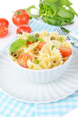 Delicious pasta with tomatoes on plate on table close-up