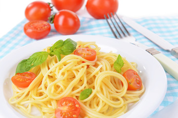 Delicious spaghetti with tomatoes on plate on table close-up