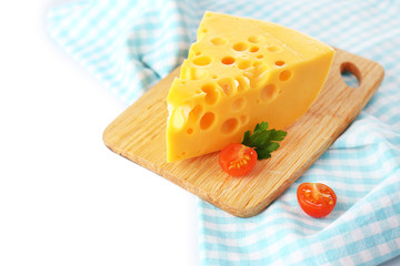 Piece of cheese and tomatoes, on wooden board, isolated on
