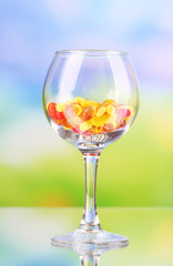 Goblet with pills on natural background