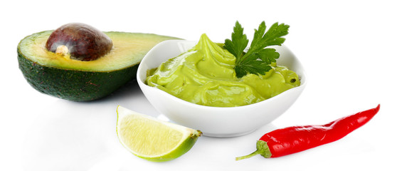 Fresh guacamole in bowl isolated on white © Africa Studio