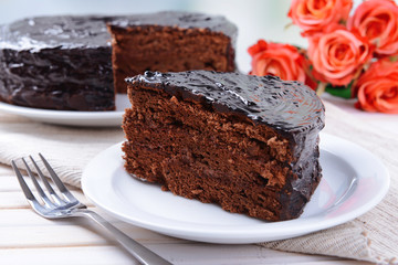 Delicious chocolate cake on plate on table close-up