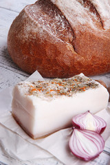 Rye bread with lard and onion on table close up