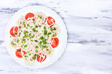 Meat dumplings - russian boiled pelmeni on wooden table