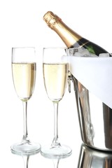 Glasses of champagne in pail, isolated on white
