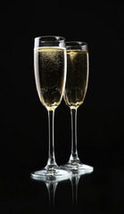 Glasses of champagne, on black background