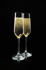 Glasses of champagne, on black background