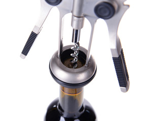 Corkscrew with bottle of wine isolated on white