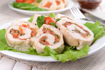 Delicious chicken roll on plate on table close-up