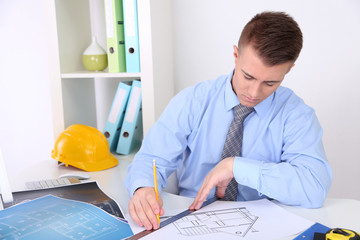 Confident young architect working at office