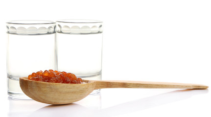 Glasses of vodka, red caviar  isolated on white