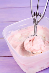 Ice cream in container and ice cream spoon