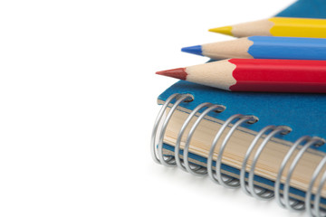 School and office stationery. Colorful pencils and notebook isol