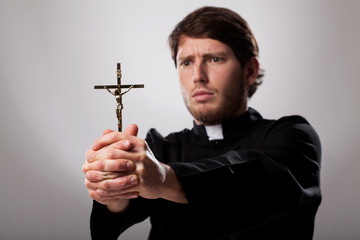 Priest with cross - obrazy, fototapety, plakaty