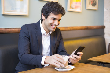 Handsome man using a cell phone in restaurant