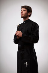 Priest with cross - obrazy, fototapety, plakaty
