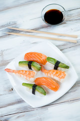 Sushi set with salmon, shrimp and avocado, vertical shot