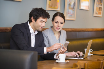 Young couple working on laptop at coffee bar,restaurant