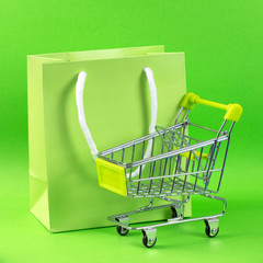 Green shopping cart and gift bag