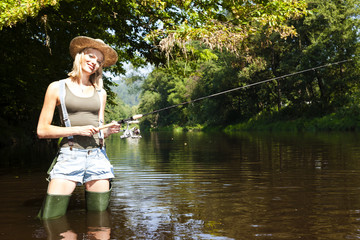 Fototapeta na wymiar woman fishing in Jizera river, Czech Republic