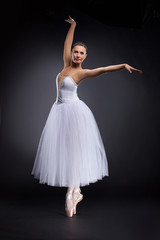 Fototapeta na wymiar beautiful young ballet dancer on black.