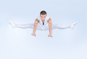 Obraz premium ballet dancer jumping on white background.