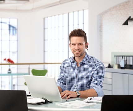 Entrepreneur working with laptop at office desk