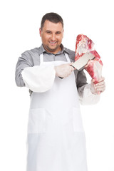 professional butcher cutting meat and smiling.