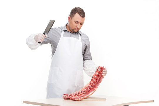 professional butcher cutting meat on table.